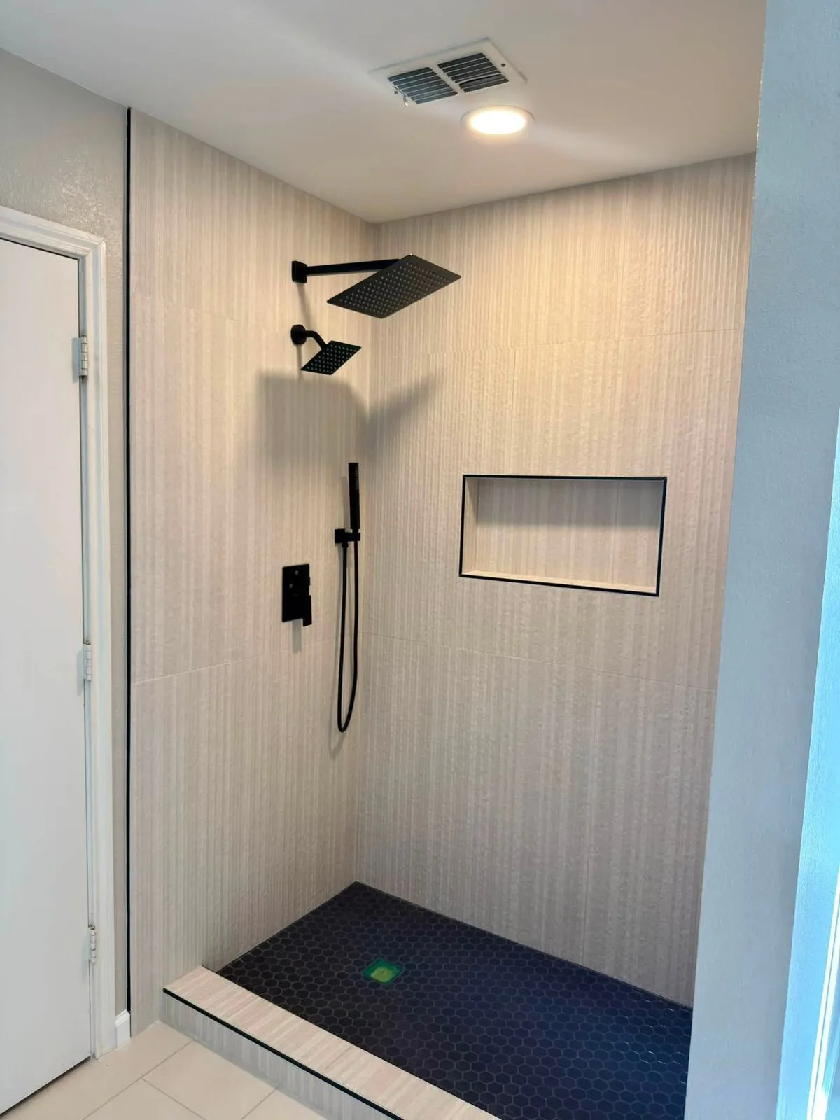 Renovated Crescentwood bathroom with walk-in shower and recessed niche