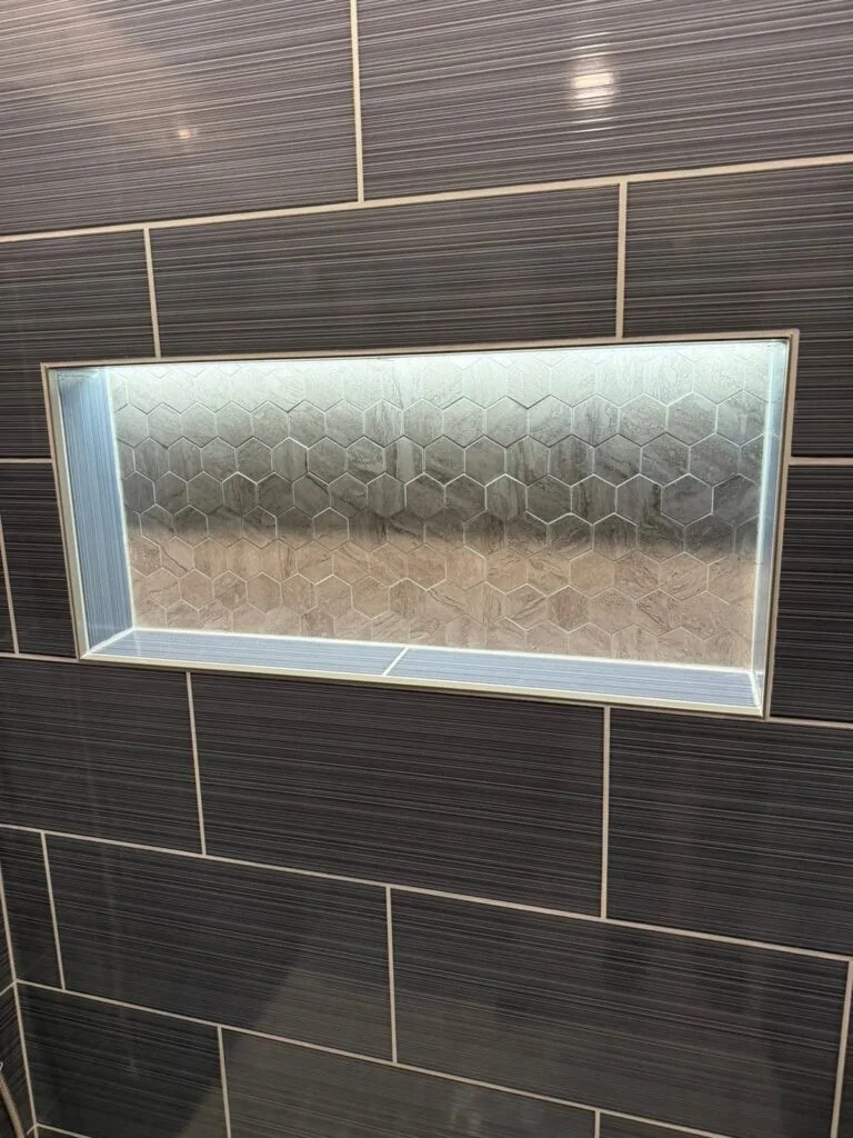 East Kildonan bathroom lit wall niche in dark tile