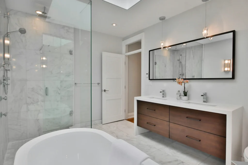 Bathroom design inspiration with a glass walk-in shower, freestanding tub and warm wood double vanity